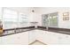 Corner of a kitchen with stainless sink, dishwasher and a view through the window at 3929 Cape Haze Dr # 101, Rotonda West, FL 33947