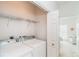Bright laundry room featuring a washer, dryer and wire shelving, conveniently located inside the home at 3929 Cape Haze Dr # 101, Rotonda West, FL 33947