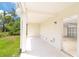 Covered patio with an open door to the garage and lush greenery surrounding the space at 3929 Cape Haze Dr # 101, Rotonda West, FL 33947