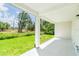 A covered patio provides a serene outdoor space with views of the lawn and nearby trees at 3929 Cape Haze Dr # 101, Rotonda West, FL 33947