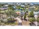 Aerial view of a canal front property showcasing a screened pool, dock, and lush landscaping at 500 Green Dolphin S Dr, Placida, FL 33946
