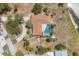 An aerial view of a single-Gathering home features a private pool and a dock on the water at 500 Green Dolphin S Dr, Placida, FL 33946