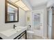 Modern bathroom with unique sink, vanity and mirror with a sliding glass door shower and exterior door at 500 Green Dolphin S Dr, Placida, FL 33946