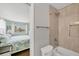 Tiled bathroom with toilet, tub, and shower, connected to bedroom at 500 Green Dolphin S Dr, Placida, FL 33946