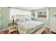 Cozy bedroom with light green walls, white furniture, and a bright window view at 500 Green Dolphin S Dr, Placida, FL 33946