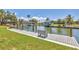 Scenic view of a private wooden dock with seating, offering direct access to the serene canal waters at 500 Green Dolphin S Dr, Placida, FL 33946