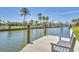 Picturesque waterfront scene featuring a private dock with seating, providing access to the beautiful canal at 500 Green Dolphin S Dr, Placida, FL 33946