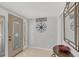 Inviting entryway featuring tiled floors, coastal decor, and a decorative mirror at 500 Green Dolphin S Dr, Placida, FL 33946