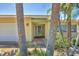 Entrance to the single story home framed by palms and tropical plants at 500 Green Dolphin S Dr, Placida, FL 33946