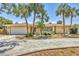 A one-story home features lush landscaping, a two-car garage, and a paved driveway at 500 Green Dolphin S Dr, Placida, FL 33946