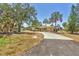 Beautiful one story home features lush landscaping, tropical greenery, and a long driveway at 500 Green Dolphin S Dr, Placida, FL 33946