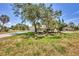 Beautiful single story home features lush green lawn, tropical landscaping, and a long driveway at 500 Green Dolphin S Dr, Placida, FL 33946