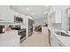 Bright kitchen with stainless appliances, quartz counters, and white cabinetry offers open floor plan at 500 Green Dolphin S Dr, Placida, FL 33946