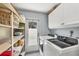 Functional laundry room with modern washer and dryer units and ample shelving at 500 Green Dolphin S Dr, Placida, FL 33946