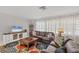 Cozy living room features plush sofas, a floral rug, and a large window for natural light at 500 Green Dolphin S Dr, Placida, FL 33946
