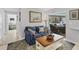 Comfortable living room with blue sofa, patterned pillows, and views of outdoor pool area at 500 Green Dolphin S Dr, Placida, FL 33946