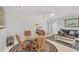 Comfortable living space with woven dining table, blue sofa, and stylish decor at 500 Green Dolphin S Dr, Placida, FL 33946