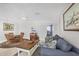 Open living space with casual dining area, blue sofa, and view into bedroom at 500 Green Dolphin S Dr, Placida, FL 33946
