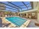 Inviting pool with screened-in enclosure, dining and seating area at 500 Green Dolphin S Dr, Placida, FL 33946