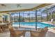 Inviting screened-in pool with lounge area, perfect for relaxing and entertaining outdoors at 500 Green Dolphin S Dr, Placida, FL 33946