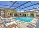 Inviting pool with screened-in enclosure, lounge chairs, and seating area at 500 Green Dolphin S Dr, Placida, FL 33946