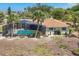 This single-Gathering home features a private screened-in pool and tropical landscaping at 500 Green Dolphin S Dr, Placida, FL 33946