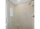 Luxurious bathroom shower features glass doors, neutral toned tiling, and a modern showerhead at 500 Green Dolphin S Dr, Placida, FL 33946