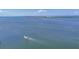 A scenic ocean view shows a small fishing boat moving across the water on a sunny day at 500 Green Dolphin S Dr, Placida, FL 33946