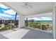 A bright balcony offers clear views of the beach with glass railings and a ceiling fan at 5000 Gasparilla Rd # 8B, Boca Grande, FL 33921