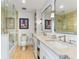 A primary bathroom features dual sinks, a glass shower, and stone countertops at 5000 Gasparilla Rd # 8B, Boca Grande, FL 33921