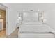A bedroom features light-colored decor and a comfortable bed with white linens at 5000 Gasparilla Rd # 8B, Boca Grande, FL 33921
