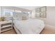 This bedroom has window shutters with neutral decor, carpet, and white furnishings at 5000 Gasparilla Rd # 8B, Boca Grande, FL 33921