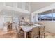 Open dining room that flows into the kitchen with large windows and plenty of natural light at 5000 Gasparilla Rd # 8B, Boca Grande, FL 33921