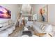 An open living room showcases a staircase and an elegant chandelier at 5000 Gasparilla Rd # 8B, Boca Grande, FL 33921