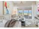Bright living room features comfortable furniture, floor to ceiling windows, and ocean views at 5000 Gasparilla Rd # 8B, Boca Grande, FL 33921
