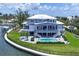 Waterfront home featuring immaculate landscaping, a pool, multiple balconies, and a convenient private dock at 565 Green Dolphin S Dr, Placida, FL 33946
