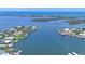 Aerial view showcasing a waterfront home in a scenic coastal community with docks at 565 Green Dolphin S Dr, Placida, FL 33946
