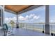 Relax on the covered balcony offering panoramic waterfront views and comfortable seating at 565 Green Dolphin S Dr, Placida, FL 33946