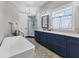 Bright bathroom with double sink vanity, freestanding tub, and large walk-in shower at 565 Green Dolphin S Dr, Placida, FL 33946