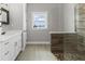 A bright bathroom features a walk-in shower and white vanity at 565 Green Dolphin S Dr, Placida, FL 33946