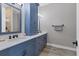 Stylish bathroom featuring double sinks, sleek blue cabinetry, and modern fixtures at 565 Green Dolphin S Dr, Placida, FL 33946