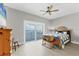 Comfortable bedroom with water view, ceiling fan, and access to a private balcony at 565 Green Dolphin S Dr, Placida, FL 33946