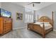 A bright bedroom with a high ceiling, a window and a painting of palm trees at 565 Green Dolphin S Dr, Placida, FL 33946