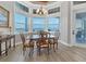 Cozy dining area with bay windows offering natural light and scenic water views at 565 Green Dolphin S Dr, Placida, FL 33946