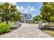 Charming home featuring a spacious driveway with manicured landscaping, enhancing curb appeal at 565 Green Dolphin S Dr, Placida, FL 33946