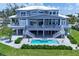 Stunning waterfront home with multiple balconies, lush landscaping, a pool, and convenient staircases at 565 Green Dolphin S Dr, Placida, FL 33946