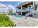 Stately home with outdoor pool, lush landscaping, and convenient staircases providing access to different levels at 565 Green Dolphin S Dr, Placida, FL 33946