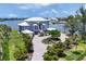 Beautiful waterfront home boasts lush landscaping, circular driveway, and stunning architectural details at 565 Green Dolphin S Dr, Placida, FL 33946