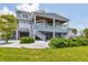 Magnificent waterfront home with lush landscaping, multiple balconies, and convenient staircases at 565 Green Dolphin S Dr, Placida, FL 33946