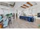 Gourmet kitchen with white cabinets, a blue island, counter seating, and wood ceiling beams at 565 Green Dolphin S Dr, Placida, FL 33946